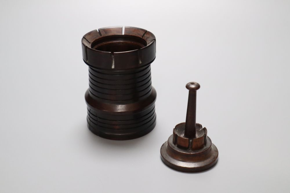 A 19th century lignum vitae turret shaped jar and cover, a similar acorn shaped string box and bowl, and a stained sycamore and engine